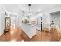 Modern kitchen with a large island, granite countertops, stainless steel appliances, and hardwood floors at 100 Inspiration Ln, Dallas, GA 30157