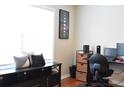 Well-organized office space with desk, storage, and natural light from a window at 1676 Northridge Dr, Morrow, GA 30260