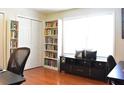 Bright office featuring bookshelves, storage cabinet, and a comfortable chair at 1676 Northridge Dr, Morrow, GA 30260