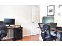 Well-lit office with desks, computers, and hardwood floors at 1676 Northridge Dr, Morrow, GA 30260