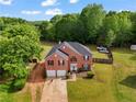 Expansive aerial view of a brick home with an oversized lot, mature trees and a long driveway at 1314 Durham Ter, Mcdonough, GA 30252