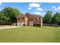 Lovely two-story brick home with a two-car garage, manicured lawn, and charming curb appeal at 1314 Durham Ter, Mcdonough, GA 30252