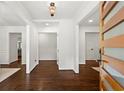 Bright foyer featuring dark wood floors, white walls, and a view into other rooms at 1749 Ridge Valley Nw Ct, Atlanta, GA 30327