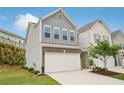 Charming two-story townhome with a two-car garage and professionally landscaped front yard at 302 Braswell Ct, Woodstock, GA 30188