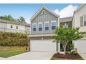 Charming two-story townhome with a two-car garage and professionally landscaped front yard at 302 Braswell Ct, Woodstock, GA 30188