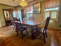 Traditional dining room featuring a chandelier, wood table and chairs, and natural light at 712 Copper Trace Way, Woodstock, GA 30189