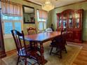 Elegant dining room with hutch, wood table, chandelier and shuttered windows, great for gatherings at 712 Copper Trace Way, Woodstock, GA 30189