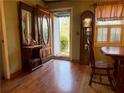 Inviting entryway features hardwood floors and an antique hall tree, offering warmth and character at 712 Copper Trace Way, Woodstock, GA 30189