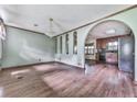 The living room features wood flooring, arched entryways, and a chandelier for an elegant touch at 712 Copper Trace Way, Woodstock, GA 30189