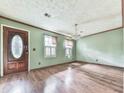 The living room has wood floors, classic trim, and a large front door at 712 Copper Trace Way, Woodstock, GA 30189