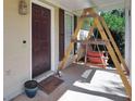 Cozy front porch featuring a hanging swing, creating a welcoming and relaxing outdoor space at 107 Gwenellen Dr, Locust Grove, GA 30248