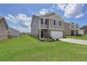 Well-kept two-story home with a manicured lawn and driveway at 157 Oliver Dr, Locust Grove, GA 30248