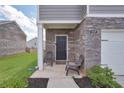 Inviting front porch with seating and stone accents at 157 Oliver Dr, Locust Grove, GA 30248