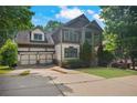 Charming two-story home with a two-car garage and a welcoming front porch in a lush, green neighborhood setting at 2584 Kickerillo Se Way, Atlanta, GA 30316