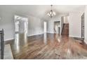 Spacious living room featuring hardwood floors, a fireplace, and a staircase at 3623 Spring Meadow Ct, Acworth, GA 30101