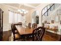 Formal dining room featuring hardwood floors, decorative lighting, and staircase at 108 Telfair Ln, Mcdonough, GA 30253