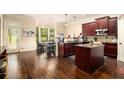 Spacious kitchen with island, dark wood cabinets, and sunlit breakfast nook at 108 Telfair Ln, Mcdonough, GA 30253