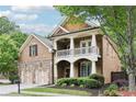 Attractive two-story brick home featuring a welcoming front porch, well-maintained landscaping, and a convenient two-car garage at 2652 Brickell Sq, Atlanta, GA 30341
