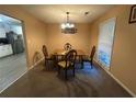 Cozy dining room with a classic chandelier and ample natural light at 661 Oak Dr, Riverdale, GA 30274