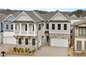Attractive two-story home with a two-car garage, upper story balcony, and neutral color scheme at 91 Batten Board Way, Woodstock, GA 30189