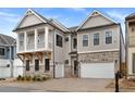 Gorgeous two-story home with stone and siding exterior, a two-car garage, and a quaint second story balcony at 91 Batten Board Way, Woodstock, GA 30189