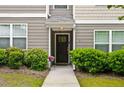 Charming front entrance with dark wood door, manicured shrubs, and a well-lit entryway at 1365 Memorial Se Dr # 12, Atlanta, GA 30317