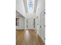 Welcoming foyer with soaring ceilings, natural light, and wood-look floors leading into the home at 1909 Riverlanding Cir, Lawrenceville, GA 30046