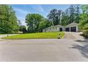 Beautiful home with a spacious driveway, lush landscaping, and a well-maintained yard at 4265 Hidden Valley Dr, South Fulton, GA 30349