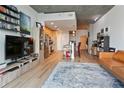 Open-concept living room and kitchen with wood floors, an island, and modern appliances at 860 Peachtree Ne St # 904, Atlanta, GA 30308