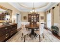 Formal dining room with a round wooden table, elegant chandelier, and classic decor for sophisticated gatherings at 3151 Amesbury Way, Duluth, GA 30096