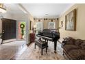 Elegant entryway featuring a grand piano, marble floors, and decorative molding, creating a welcoming ambiance at 3151 Amesbury Way, Duluth, GA 30096