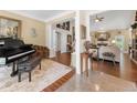 Open-concept living area with hardwood floors, neutral decor, and seamless transition to other rooms at 3151 Amesbury Way, Duluth, GA 30096