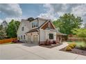Side view of a charming two-story home with a two-car garage and inviting walkway at 1142 Wiley Bridge Rd, Woodstock, GA 30188
