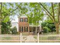 Charming two-story home featuring a brick facade, inviting front porch, and white picket fence at 3087 Dunton Se St, Smyrna, GA 30080