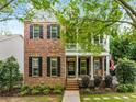 Charming two-story home featuring a brick facade, inviting front porch and manicured landscaping at 3087 Dunton Se St, Smyrna, GA 30080