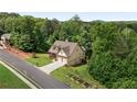 Scenic aerial shot of the property showcasing its lush, wooded surroundings, well-kept lawn, and proximity to nature at 42 Treemont Se Dr, Cartersville, GA 30121