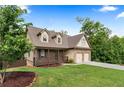 Inviting two-story home with a charming front porch, a well-maintained lawn, and an attached two-car garage at 42 Treemont Se Dr, Cartersville, GA 30121