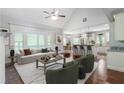 Sun-filled living room flows into the kitchen with vaulted ceiling and large windows at 42 Treemont Se Dr, Cartersville, GA 30121