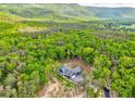 Beautiful home surrounded by vibrant green trees, offering privacy and scenic views at 555 E Valley Ne Rd, Rydal, GA 30171