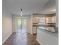 Bright kitchen with white cabinets, granite countertops, stainless steel sink, and patio access at 5723 Fieldstone Dr, Lithonia, GA 30038
