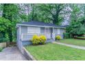 Cozy home with manicured lawn, welcoming porch, and convenient driveway at 941 Reed Ave, Atlanta, GA 30344