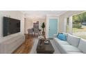 Inviting living room showcases a contemporary design with sleek furniture and wood flooring at 1398 Woodland Ave, Atlanta, GA 30316