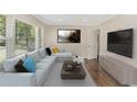 Bright living room with a large window, modern sofa, and stylish decor at 1398 Woodland Ave, Atlanta, GA 30316