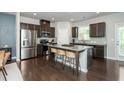 Spacious kitchen features dark cabinets, stainless steel appliances, and a large granite island at 2444 Coosa Vly, Atlanta, GA 30339