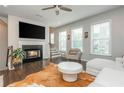 Cozy living room with fireplace, hardwood floors, and an abundance of natural light at 2444 Coosa Vly, Atlanta, GA 30339
