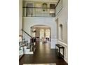 Bright foyer with hardwood floors and stairway featuring decorative trim details and high ceilings at 365 Autumn Breeze Dr, Roswell, GA 30075
