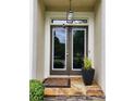 Close-up of the front door with decorative lighting and stone pathway at 365 Autumn Breeze Dr, Roswell, GA 30075