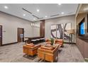 Stylish lounge featuring comfortable leather seating, modern artwork, and a bar height table with bar stools at 855 Peachtree Ne St # 2713, Atlanta, GA 30308