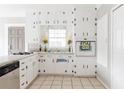 Well-lit kitchen boasting ample white cabinetry and tiled floors, perfect for culinary enthusiasts at 1624 Beecher Sw St, Atlanta, GA 30310
