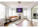 Bright living room with hardwood floors, large windows, and a decorative fireplace with neon sign at 1624 Beecher Sw St, Atlanta, GA 30310